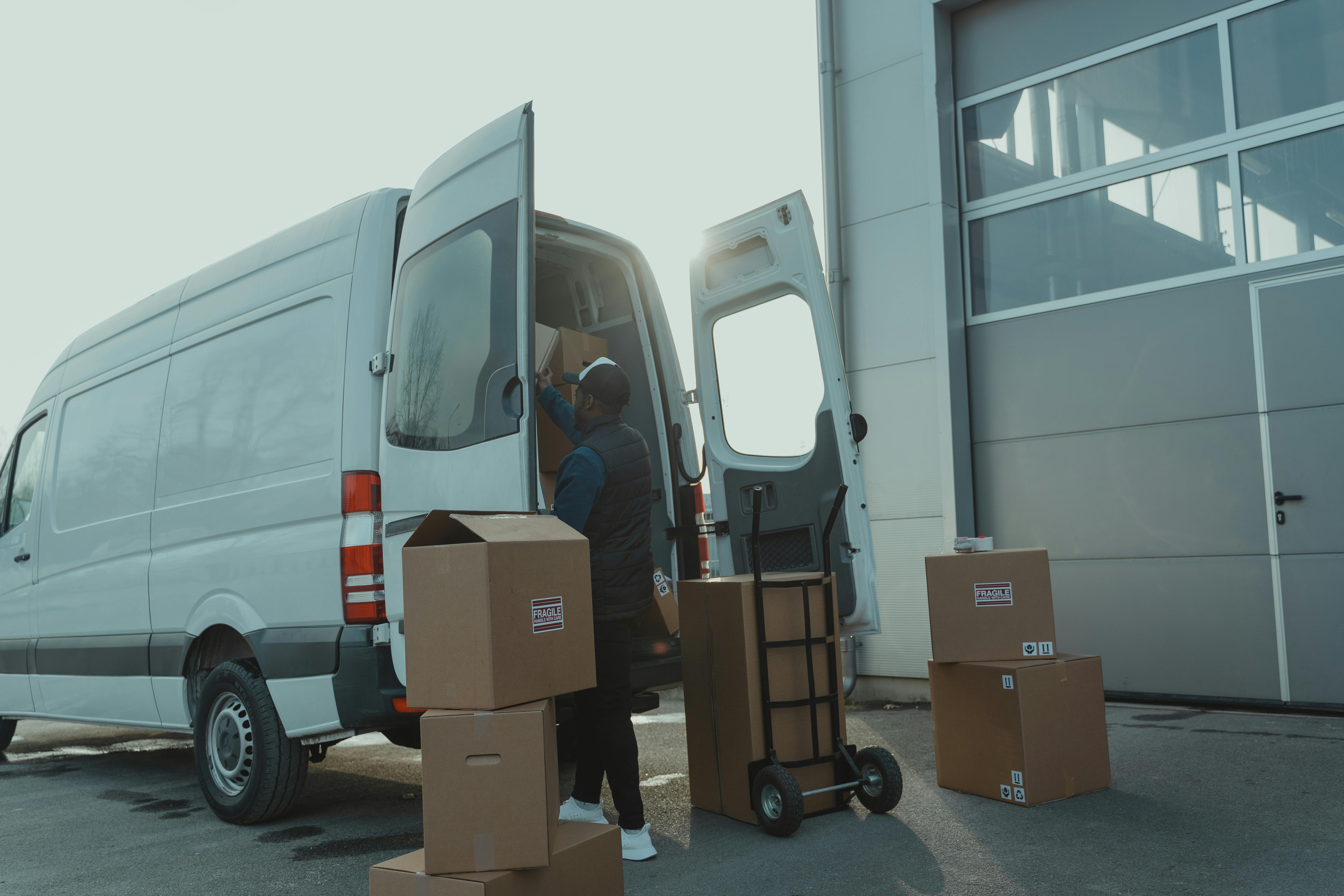 Moving crew loading boxes into a van